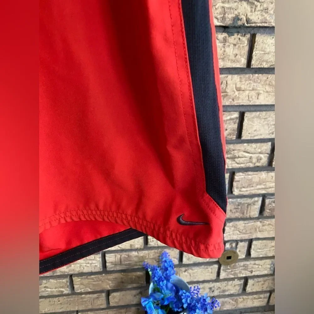 Red and black Nike swim trunks‎